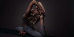 woman in blue denim jeans lying on black floor